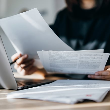 person with papers on desk